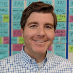 Image of Casey McArdle in front of post it notes.