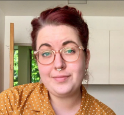 woman with red hair and glasses