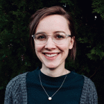 A woman with brown hair wearing glasses