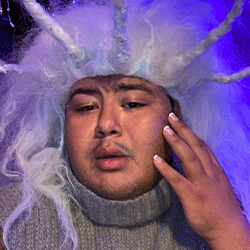 A person wearing a purple wig