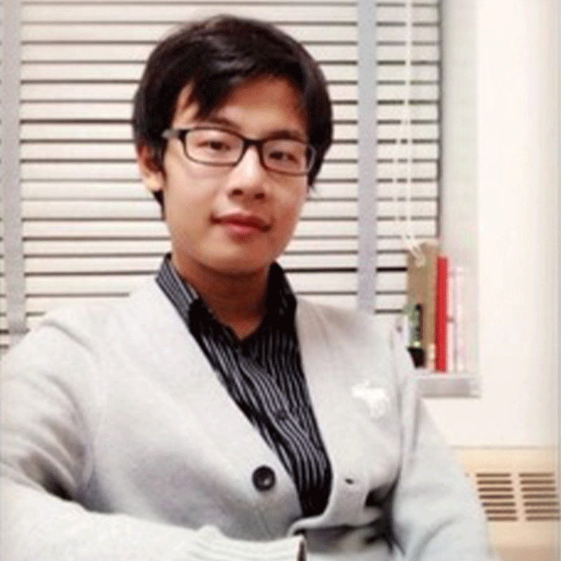 A young man in glasses and a white sweater