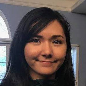 Headshot of a young woman with long dark hair