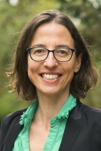 Portrait of person smiling outdoors.