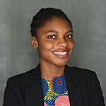 smiling woman wearing colorful blouse and black jacket