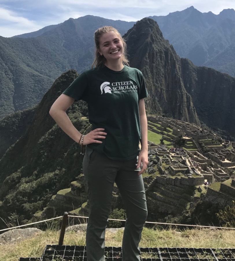 woman standing in front of machu picchu