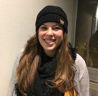 portrait of a girl with brown hair wearing a black hat and scarf 