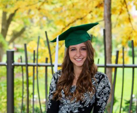 portrait of a girl wearing a graduation hat with light brown hair wearing a black and white dress