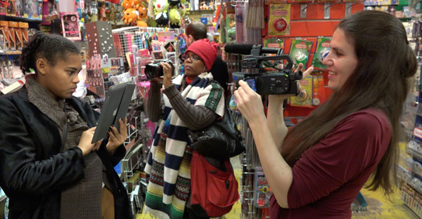 a group of women filming each other in a store