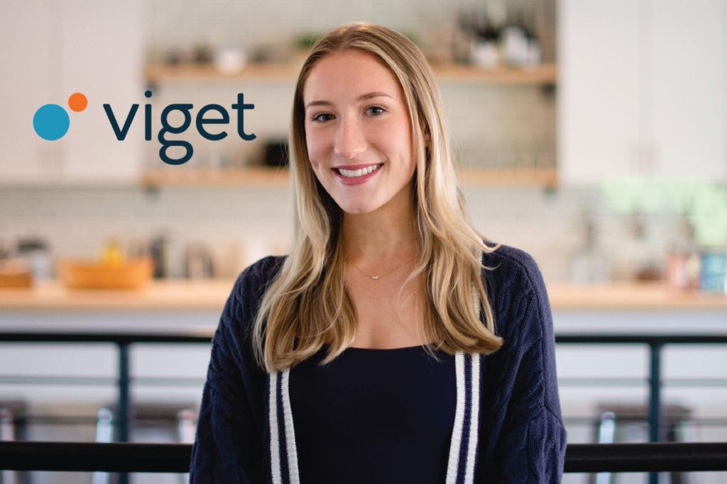 Head and shoulder image of woman smiling with long blonde hair and the word "Viget" in the top left corner. 